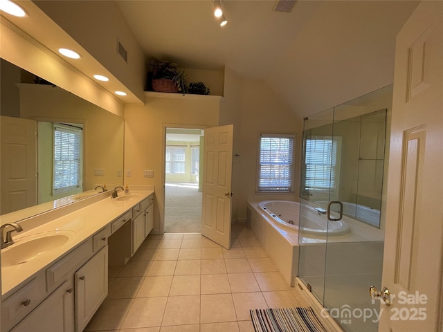 bathroom featuring tile patterned floors, vanity, shower with separate bathtub, and a high ceiling