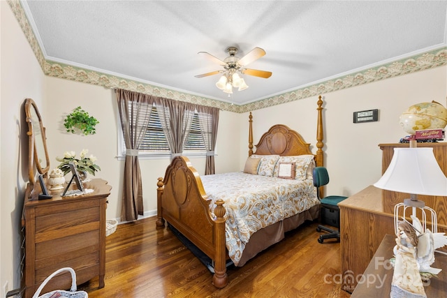 bedroom with a textured ceiling, dark hardwood / wood-style flooring, ceiling fan, and ornamental molding