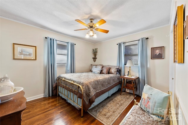 bedroom featuring ceiling fan, crown molding, dark wood-type flooring, and a textured ceiling