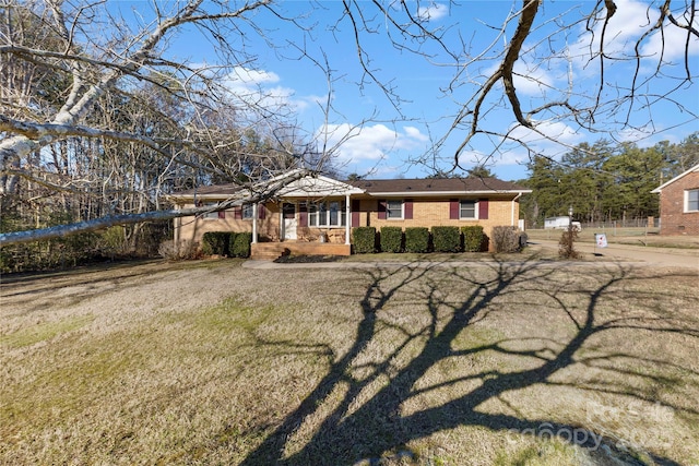 view of front of home with a front yard and covered porch