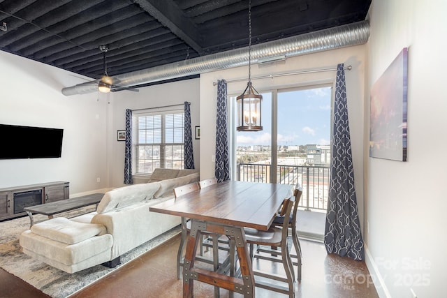 dining room with concrete flooring and ceiling fan