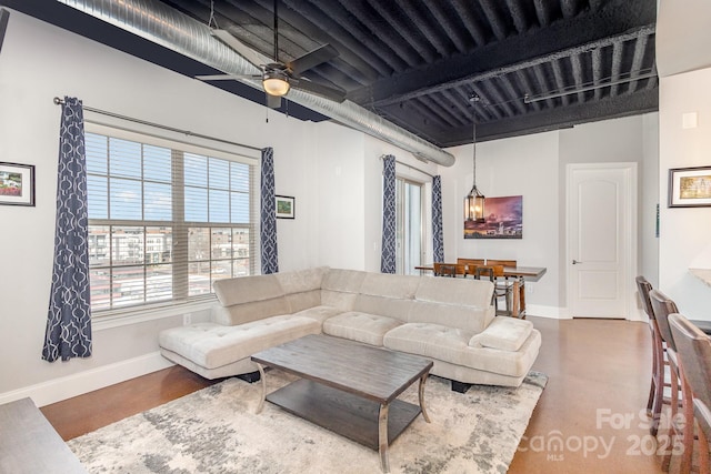 living room with beamed ceiling and ceiling fan