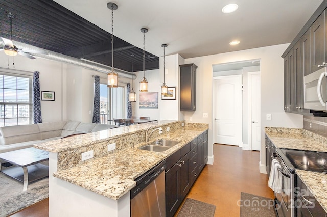 kitchen with dark brown cabinetry, sink, hanging light fixtures, and appliances with stainless steel finishes