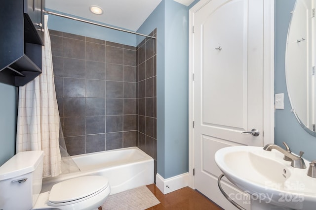 full bathroom with shower / tub combo, toilet, and sink