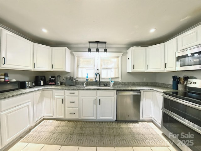 kitchen featuring white cabinets, appliances with stainless steel finishes, light tile patterned floors, and sink