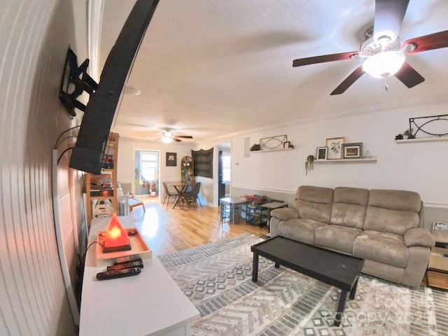 living room with hardwood / wood-style flooring and ceiling fan