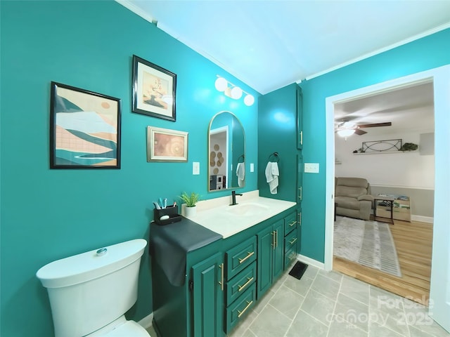 bathroom with vanity, crown molding, tile patterned flooring, ceiling fan, and toilet