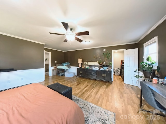 bedroom with light hardwood / wood-style floors, ceiling fan, and ornamental molding