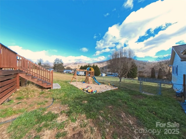 view of yard with a mountain view and a playground