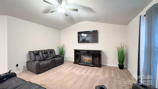 carpeted living room featuring ceiling fan and vaulted ceiling