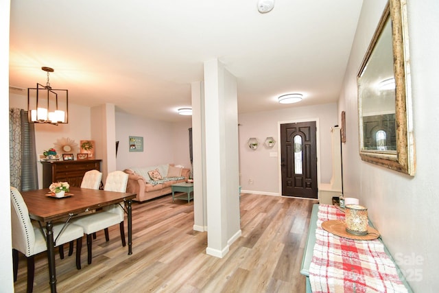 entryway featuring light hardwood / wood-style floors and a notable chandelier