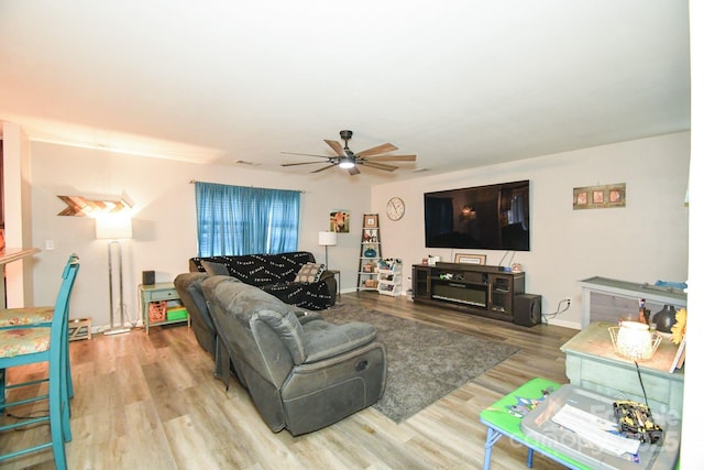 living room with hardwood / wood-style floors and ceiling fan