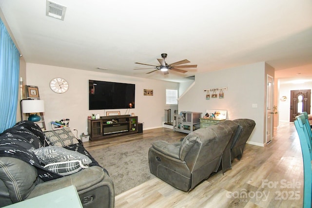 living room with ceiling fan and wood-type flooring