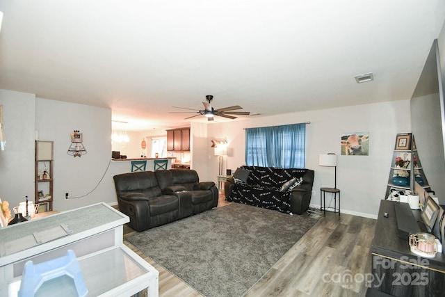 living room with hardwood / wood-style flooring and ceiling fan