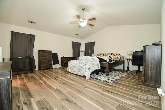 bedroom with ceiling fan, wood-type flooring, and lofted ceiling