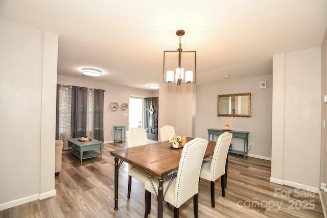 11677 Striker Ln, Midland, NC 28107 - dining area with wood finished floors, baseboards, and a chandelier