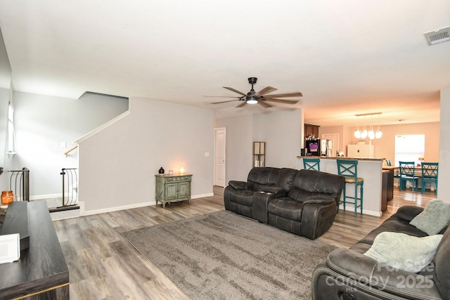 11677 Striker Ln, Midland, NC 28107 - living room with ceiling fan, wood finished floors, baseboards, and a chandelier