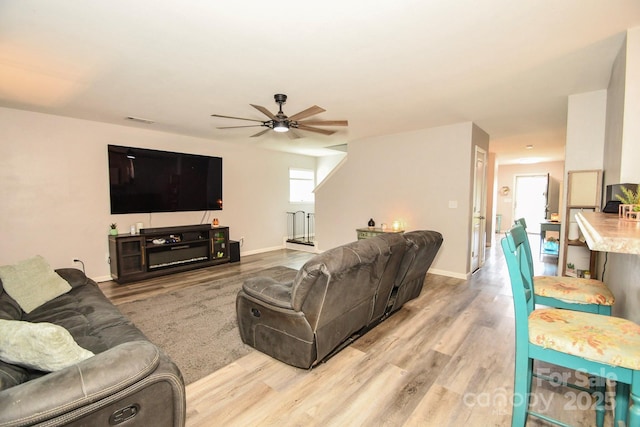 11677 Striker Ln, Midland, NC 28107 - living room featuring wood finished floors, a ceiling fan, and baseboards