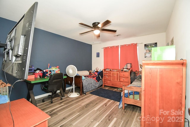 11677 Striker Ln, Midland, NC 28107 - bedroom featuring wood finished floors, an office area, a ceiling fan, and baseboards