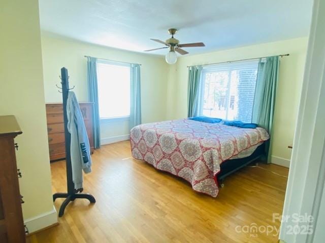 bedroom with hardwood / wood-style floors and ceiling fan