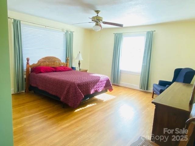 bedroom with ceiling fan and light hardwood / wood-style flooring