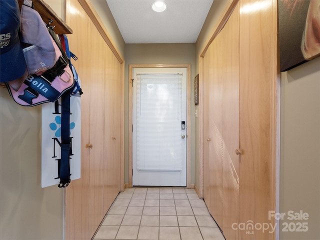 doorway to outside featuring light tile patterned floors