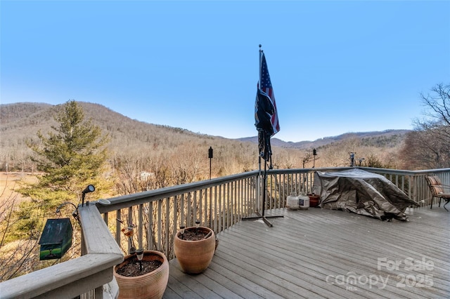 wooden deck with a mountain view