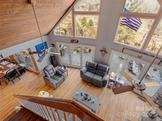 living room with wood ceiling, wood-type flooring, high vaulted ceiling, and french doors