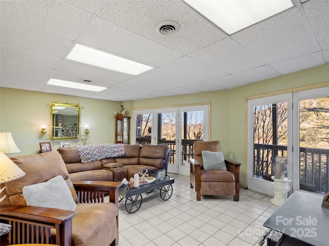 living room with a drop ceiling