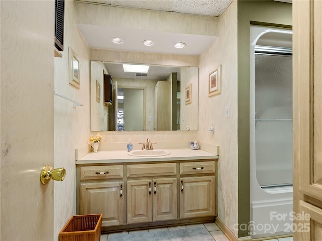 bathroom with tile patterned floors, vanity, and walk in shower