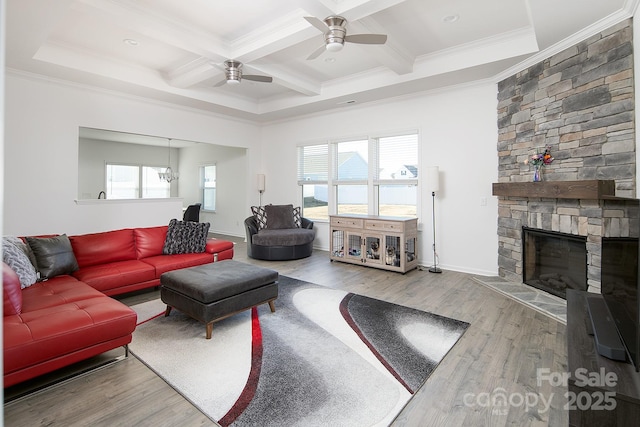 living room featuring a fireplace, hardwood / wood-style floors, beamed ceiling, and ornamental molding