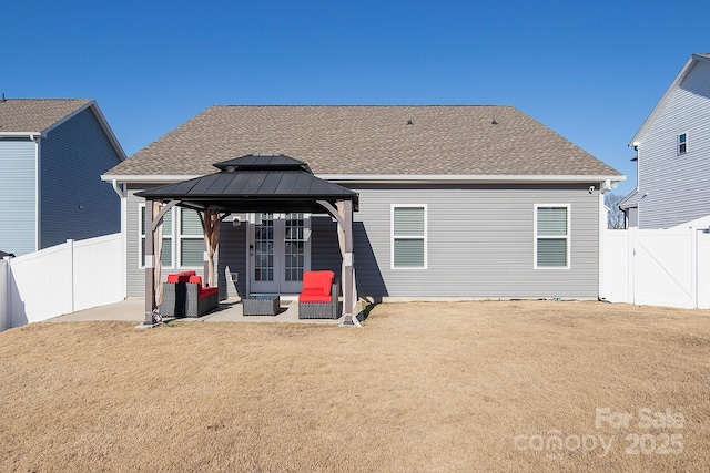 rear view of property with a gazebo, a patio area, and an outdoor living space