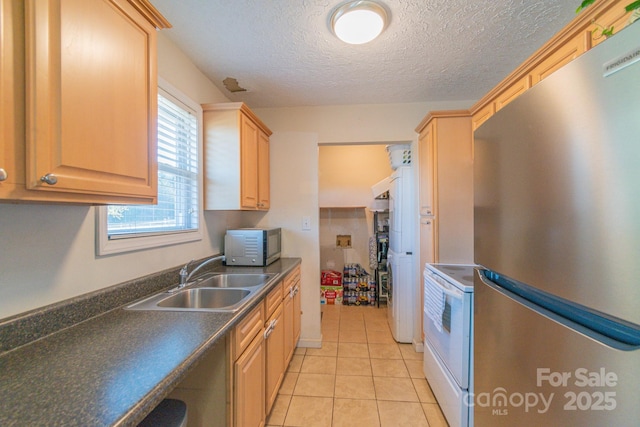 kitchen with stainless steel refrigerator, sink, light brown cabinets, white range with electric stovetop, and light tile patterned floors