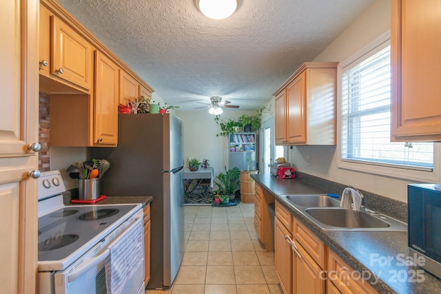 kitchen featuring ceiling fan, sink, white range with electric cooktop, a textured ceiling, and light tile patterned floors