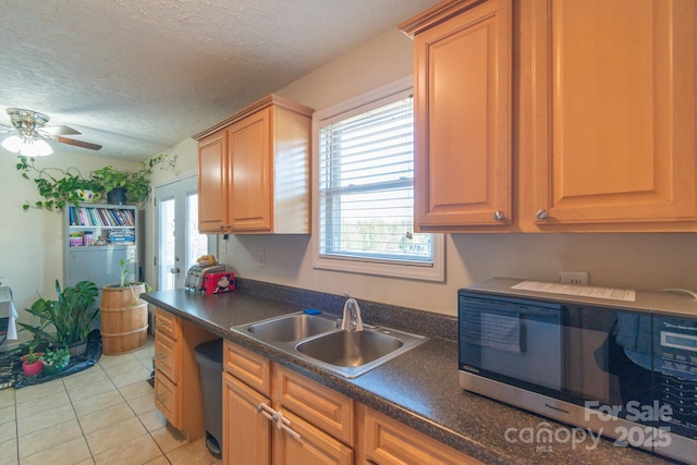 kitchen with a textured ceiling, plenty of natural light, and sink