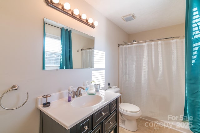 bathroom with curtained shower, tile patterned flooring, vanity, and toilet