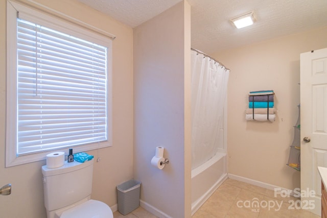 full bathroom featuring shower / bath combination with curtain, a textured ceiling, vanity, tile patterned flooring, and toilet