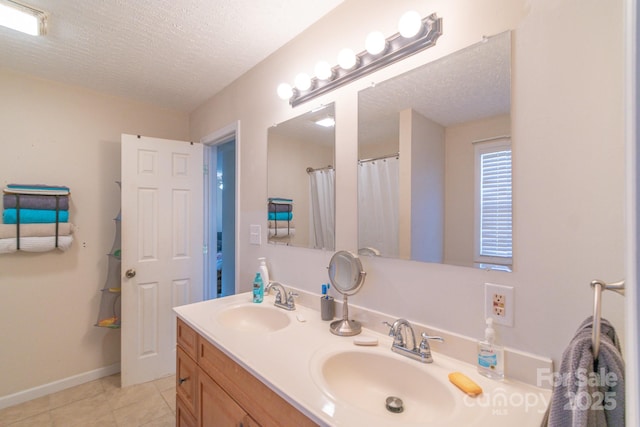 bathroom featuring vanity, a textured ceiling, and tile patterned flooring