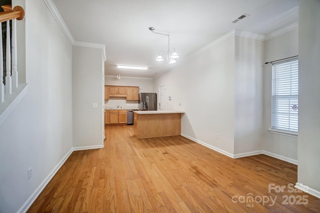 kitchen with light hardwood / wood-style flooring, appliances with stainless steel finishes, a notable chandelier, ornamental molding, and decorative light fixtures