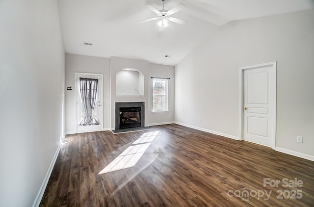 unfurnished living room with lofted ceiling, dark hardwood / wood-style floors, and ceiling fan