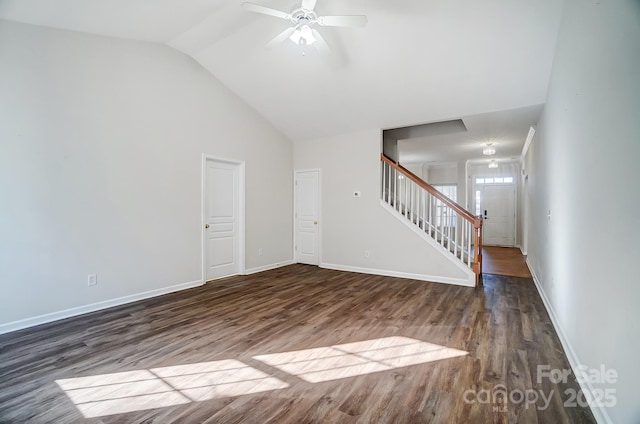 unfurnished living room with lofted ceiling, dark hardwood / wood-style floors, and ceiling fan