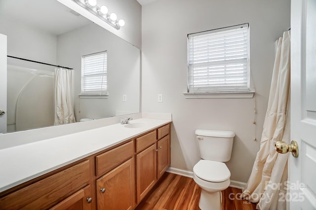 bathroom with vanity, wood-type flooring, and toilet