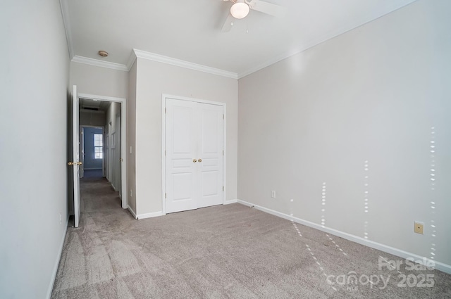 unfurnished bedroom featuring ornamental molding, ceiling fan, and carpet flooring