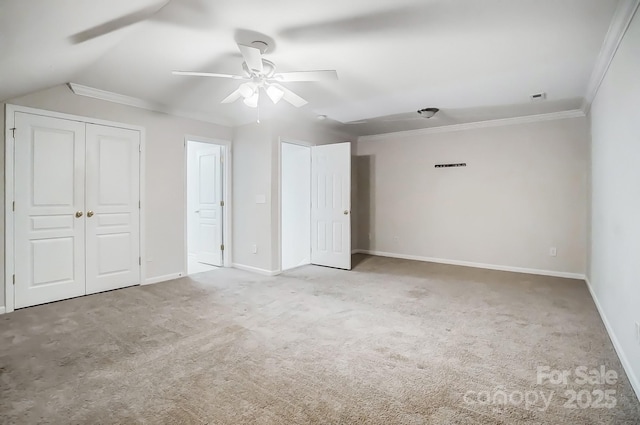 unfurnished bedroom featuring ceiling fan, ornamental molding, light colored carpet, and lofted ceiling