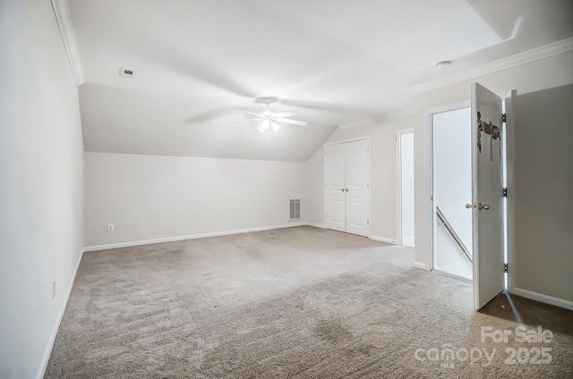 bonus room with vaulted ceiling, ceiling fan, and dark colored carpet