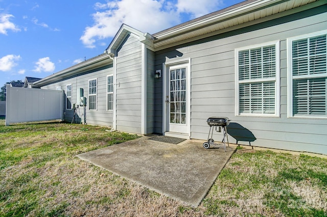 rear view of property featuring a yard and a patio area