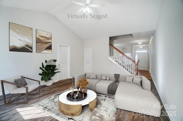 living room with hardwood / wood-style flooring, vaulted ceiling, and ceiling fan