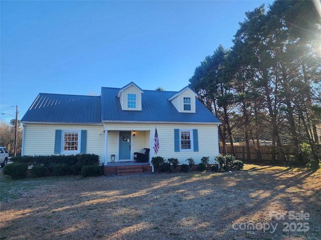 cape cod home featuring a porch