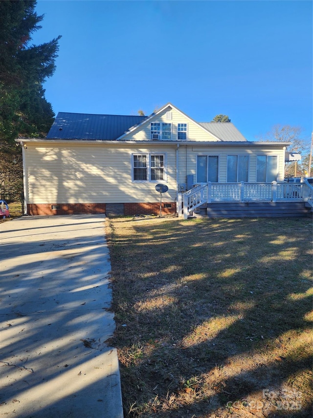 back of house with a lawn