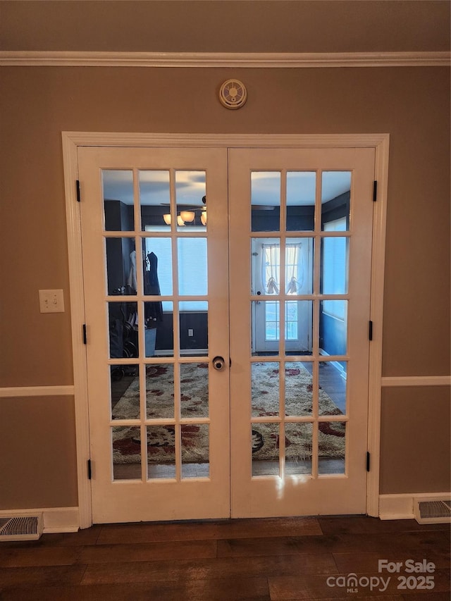 doorway to outside featuring crown molding, french doors, and dark wood-type flooring